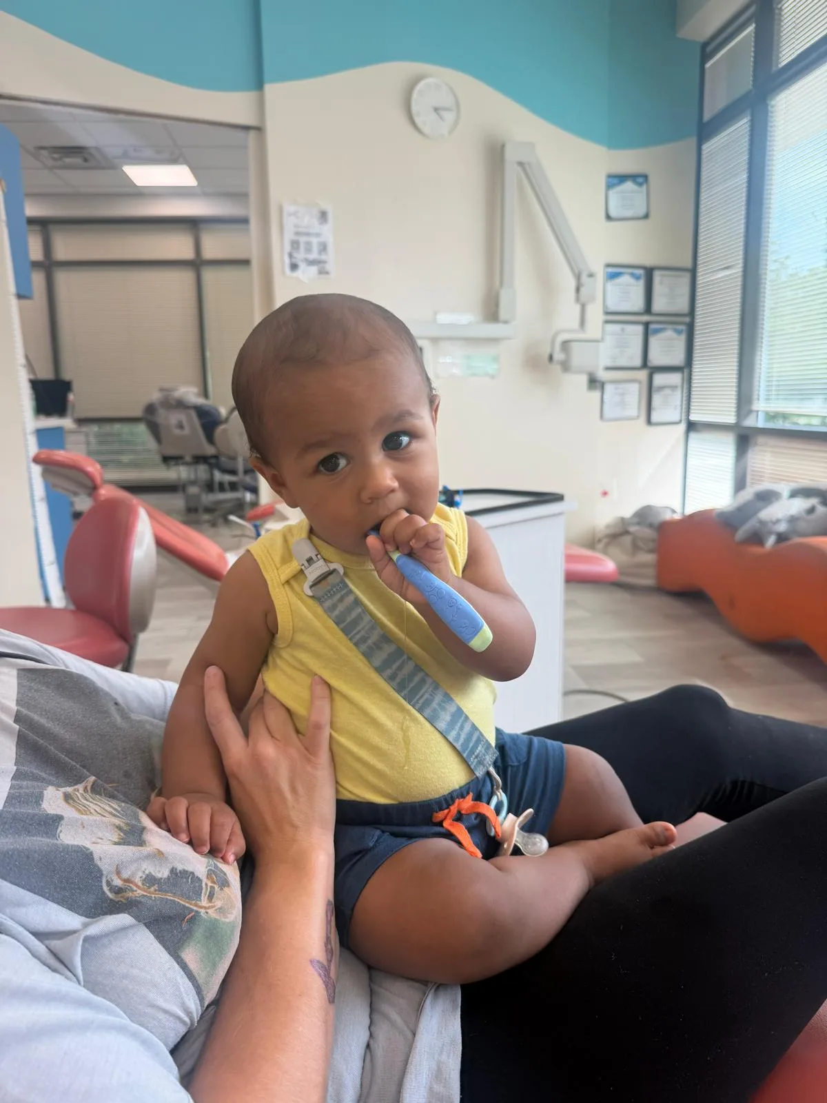 Smiling toddler in the dental chair at his first checkup