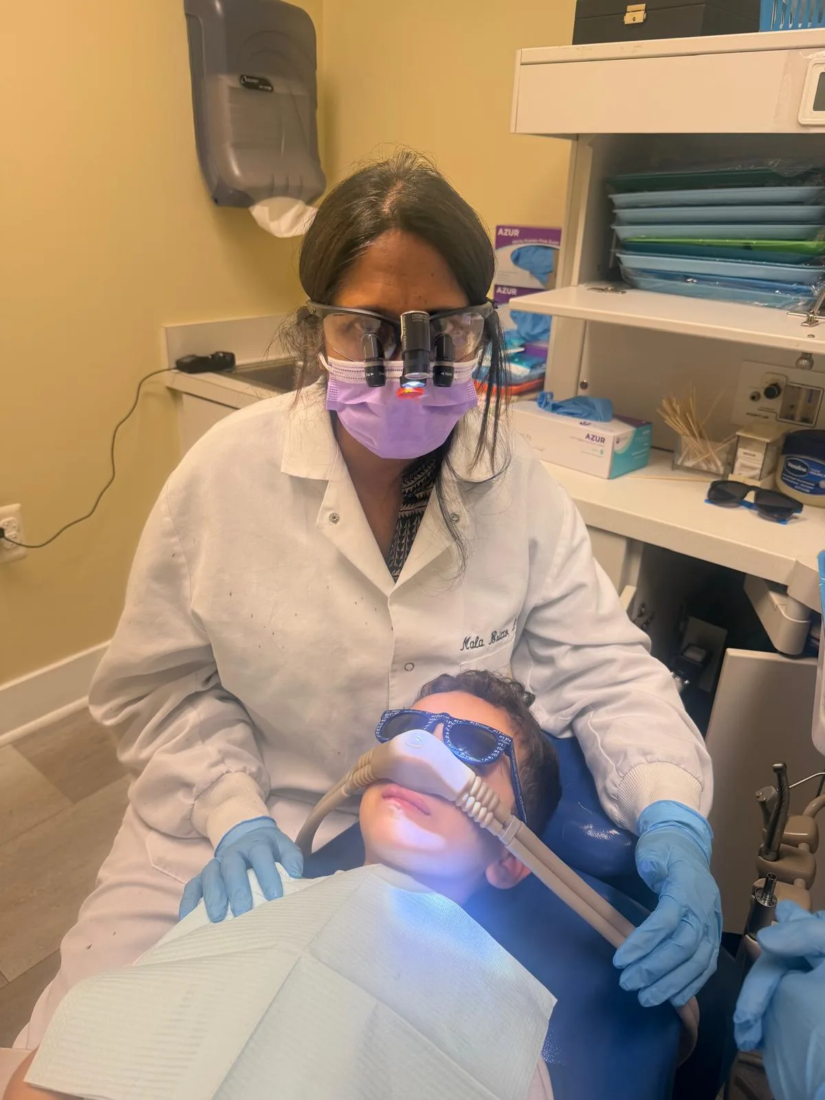 Dr. Mala Britto treating a child using nitrous oxide sedation